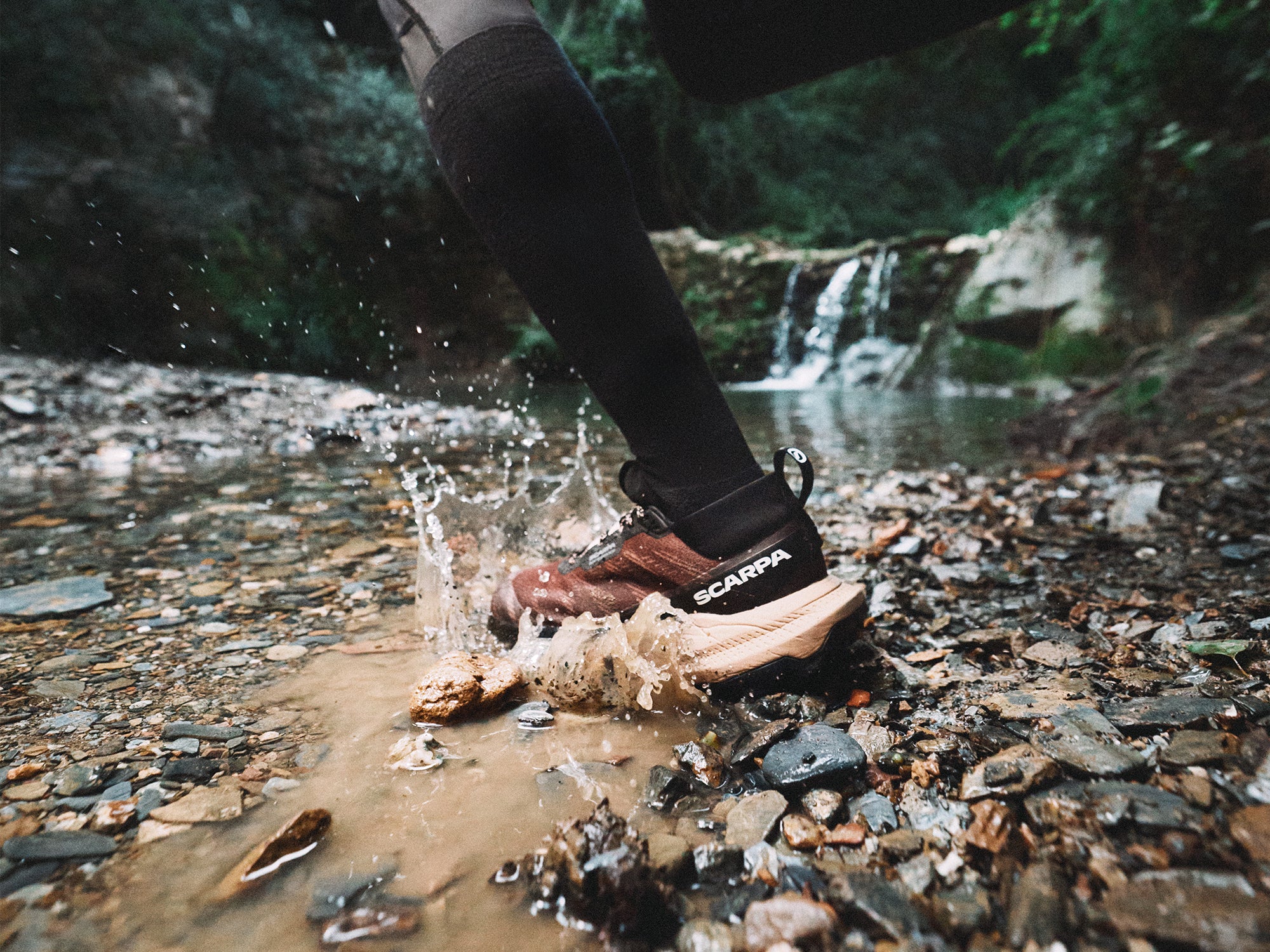 A close-up action shot of a trail runner with SCARPA's Golden Gate LT WP trail running shoes.