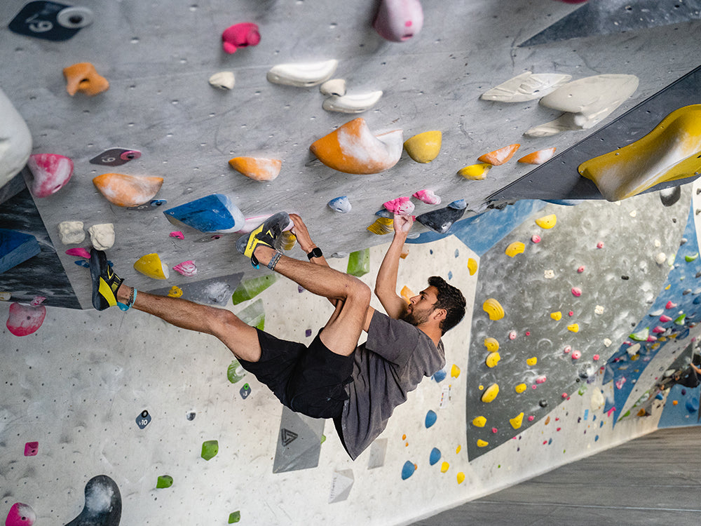 Climber on an indoor rock climbing wall with Arpia V