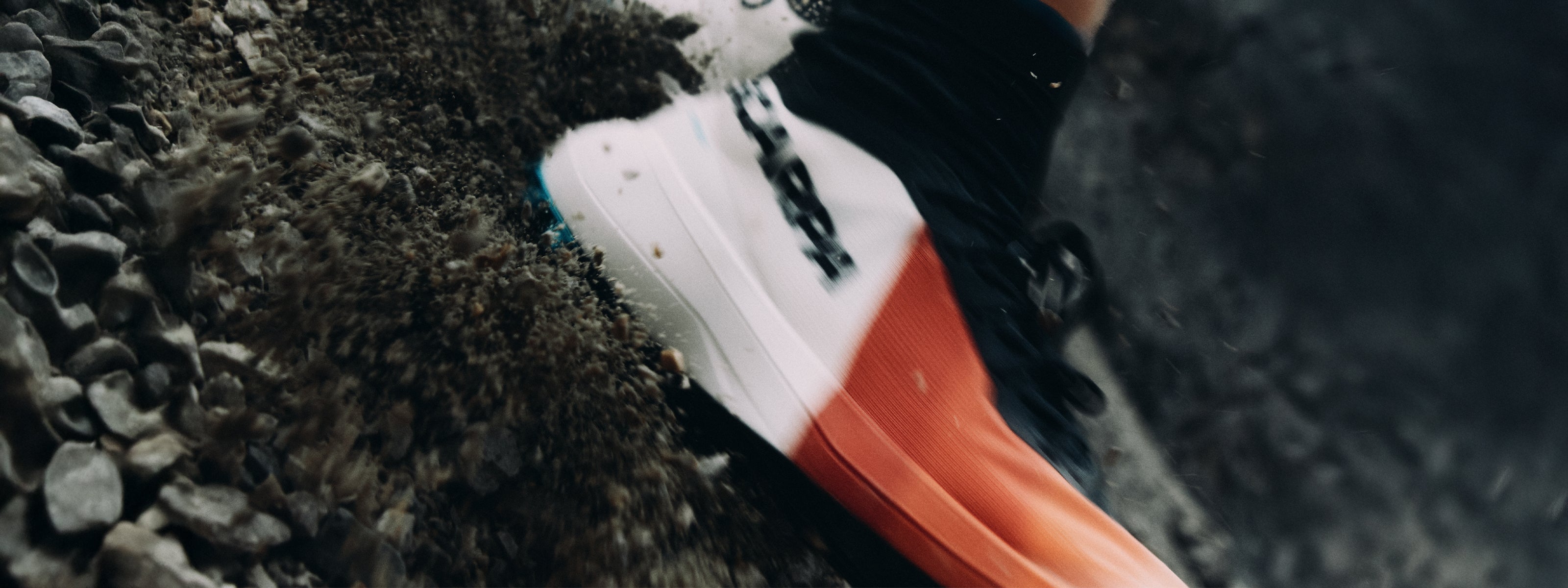 A close-up action shot of a trail runner wearing SCARPA Alien trail running shoes.