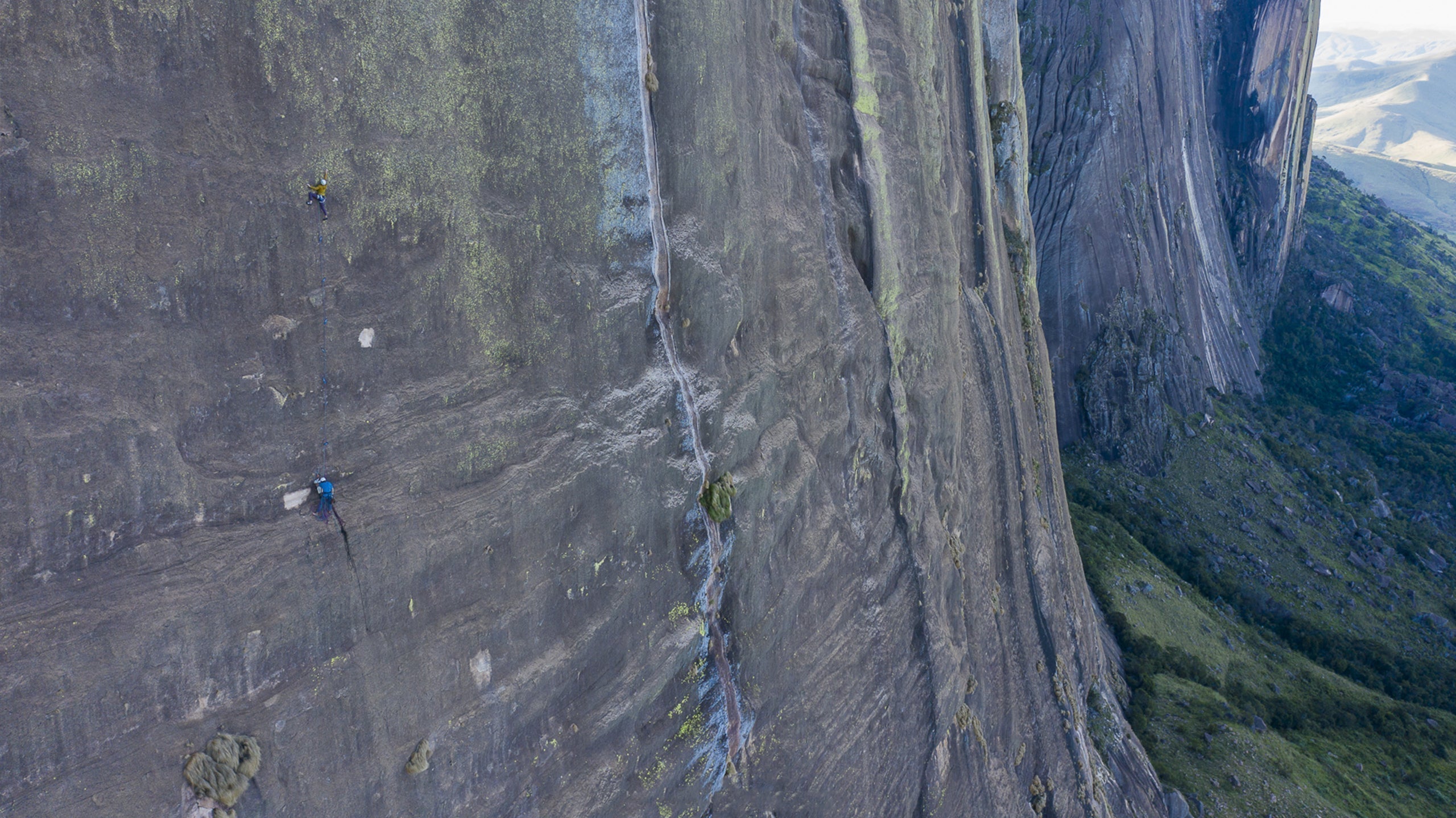 Jan Novak climbing a massive granite wall in Madagascar, wearing SCARPA Drago LV climbing shoes