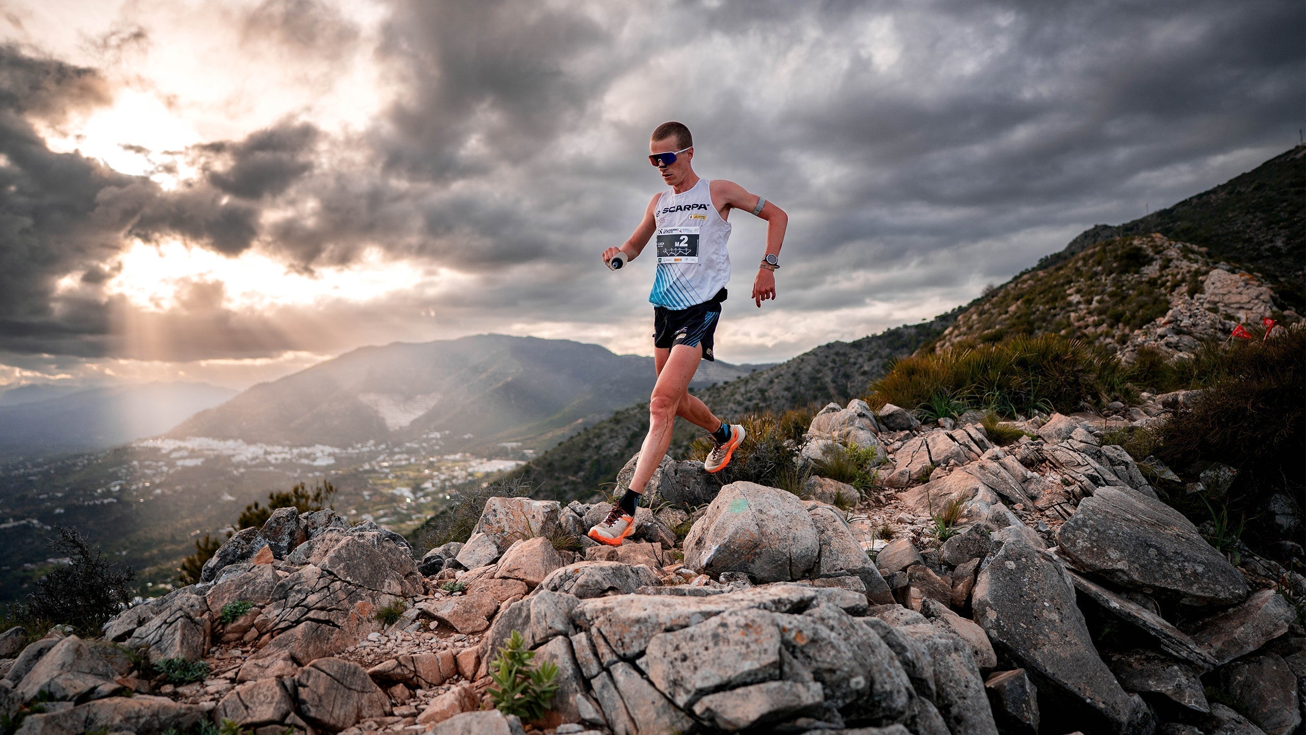 Luca Del Pero trail running on rocky cliffs wearing SCARPA Spin Ultra 2 trail running shoes
