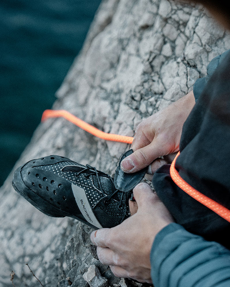 Close-up of SCARPA Blackbird lacing system with feather-shaped strap closure.