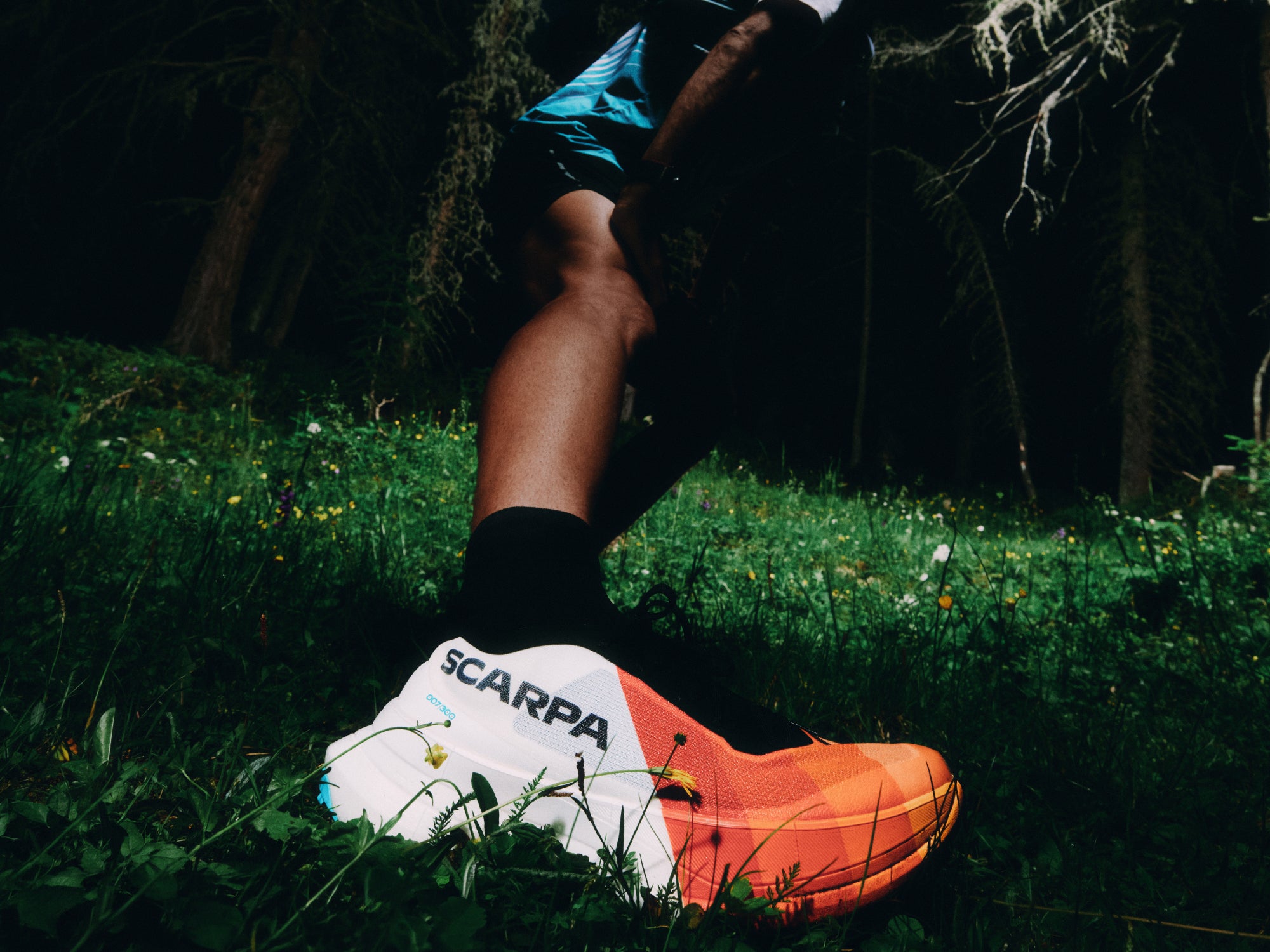 A close-up of a trail runner wearing SCARPA's Alien Ultra trail running shoes.