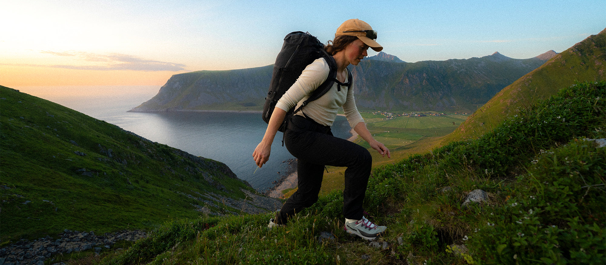 Person hiking on a mountain trail with SCARPA Mustang TRK GTX trekking shoe