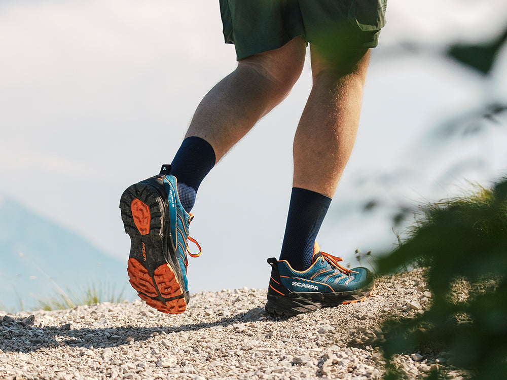 Hiker on a mountain trail wearing Rush 2 GTX
