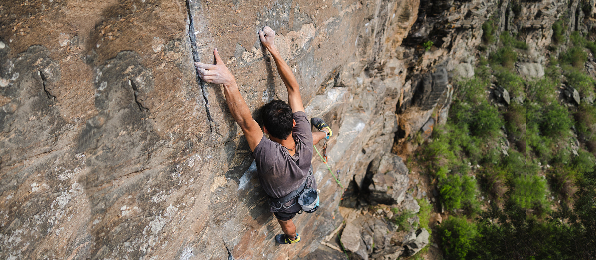 Climber on a rocky wall wearing Arpia V