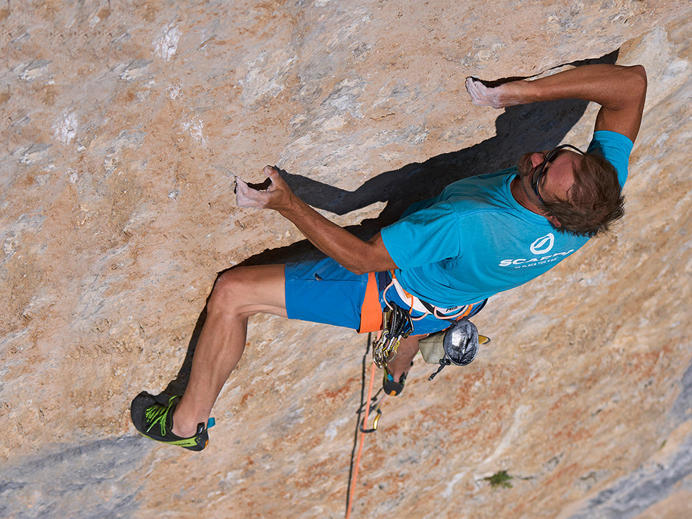 Heinz Mariacher climbing the Trainspotting wall at Val San Nicolò with Mago climbing shoes