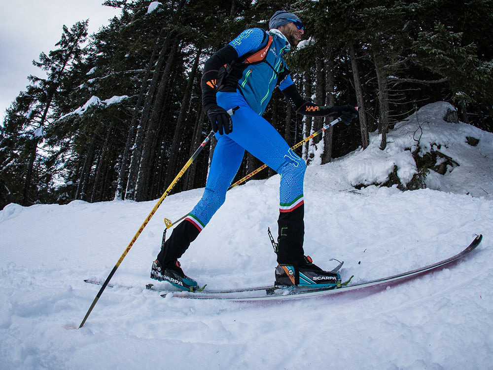 Close-up of Mattero Eydallin skiing with Alien 4.0 in a snowy forest
