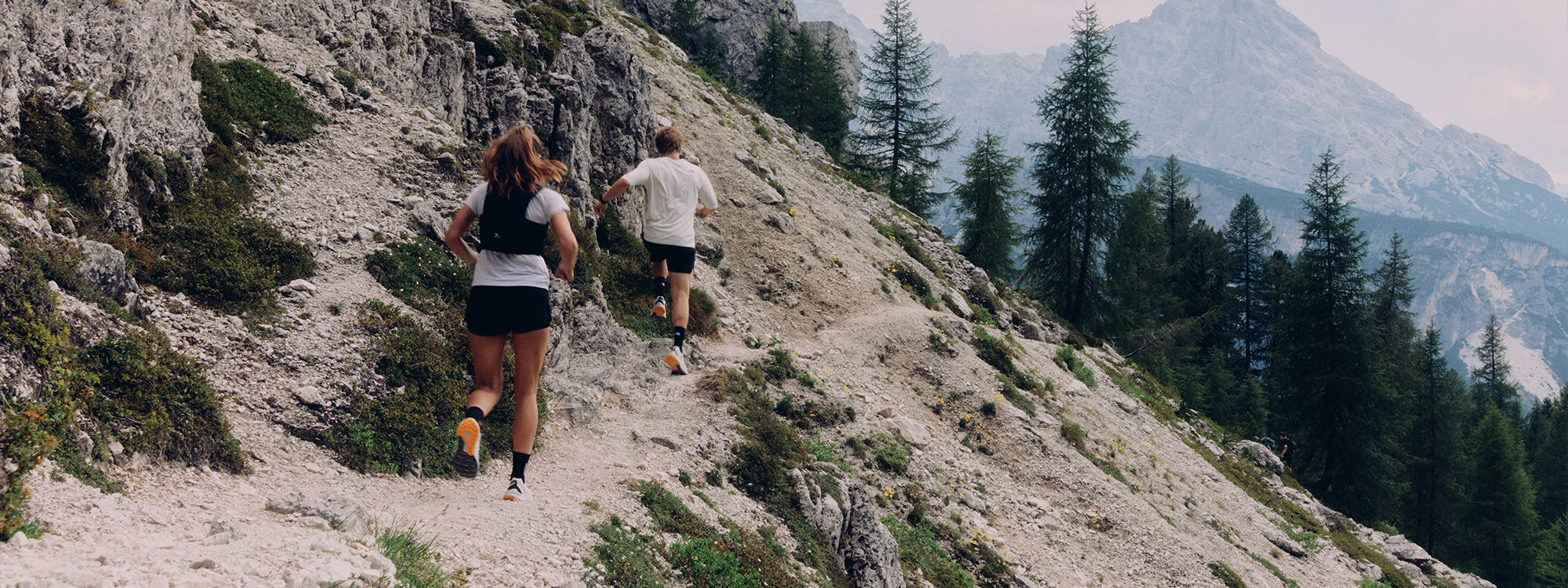 Two trail runners from behind wearing SCARPA Spin Planet trail running shoes.