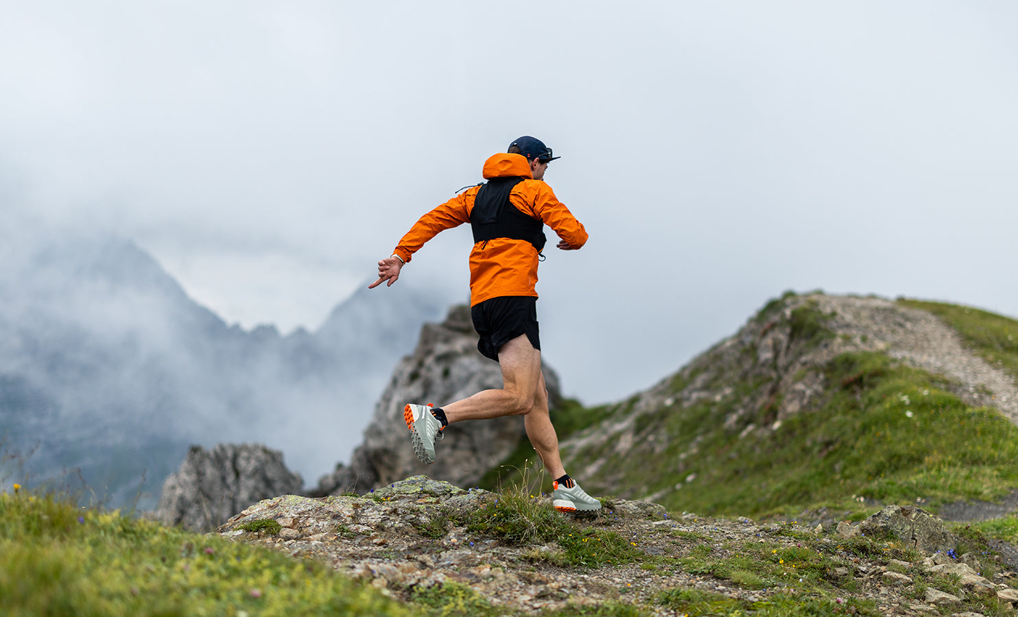 Trail runner on a mountain trail with SCARPA's trail running shoes