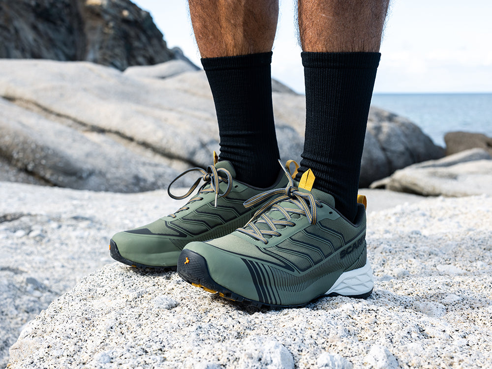 Runner standing on the rocks wearing Ribelle Run LT WP