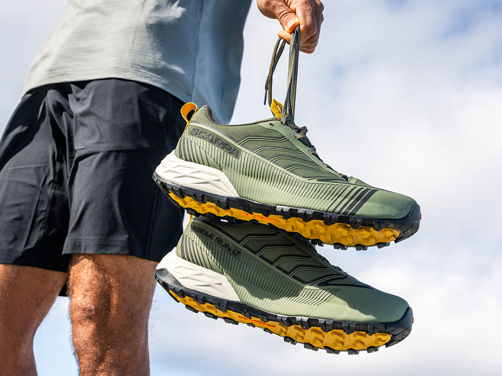 Runner holding Ribelle Run LT shoes